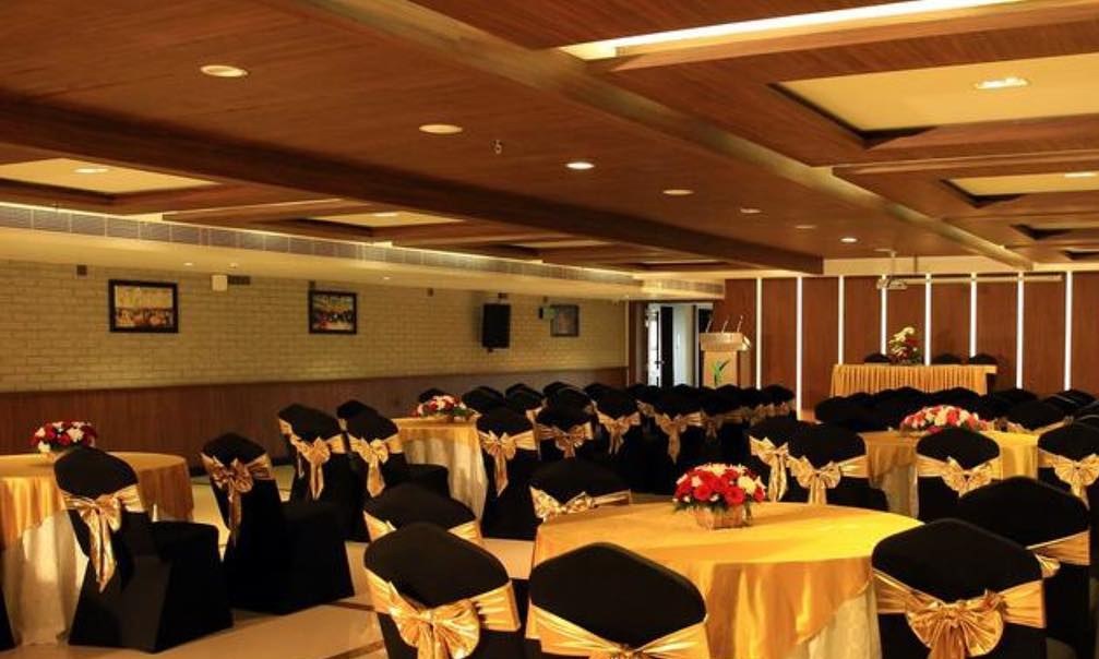 Yash banquet hall set up with gold sashes for a wedding reception