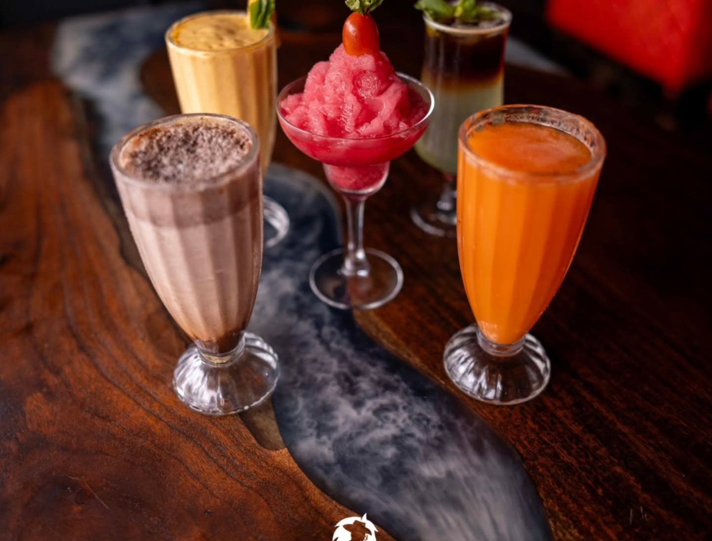 Cavallo cocktails on a live-edge dark wood bar