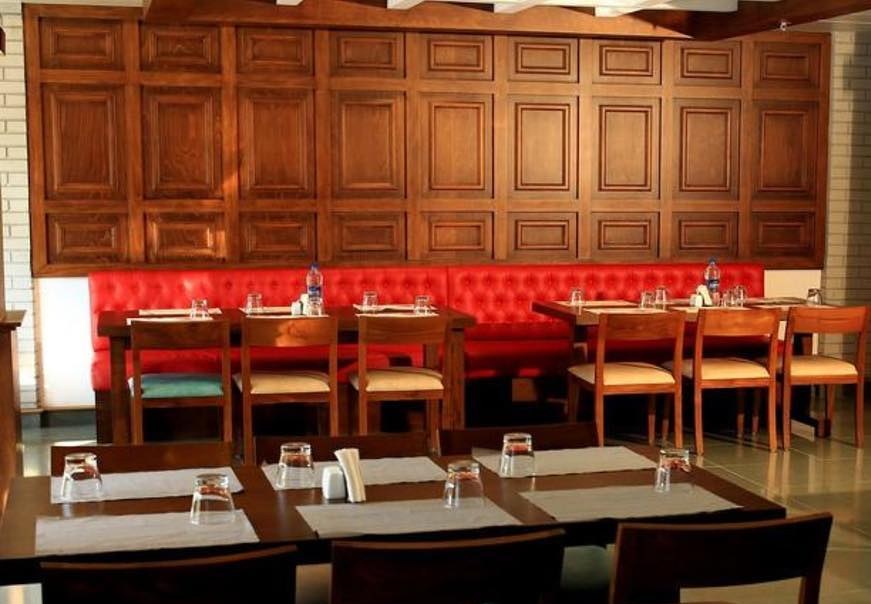 Calicut Chimney restaurant interior with red banquette