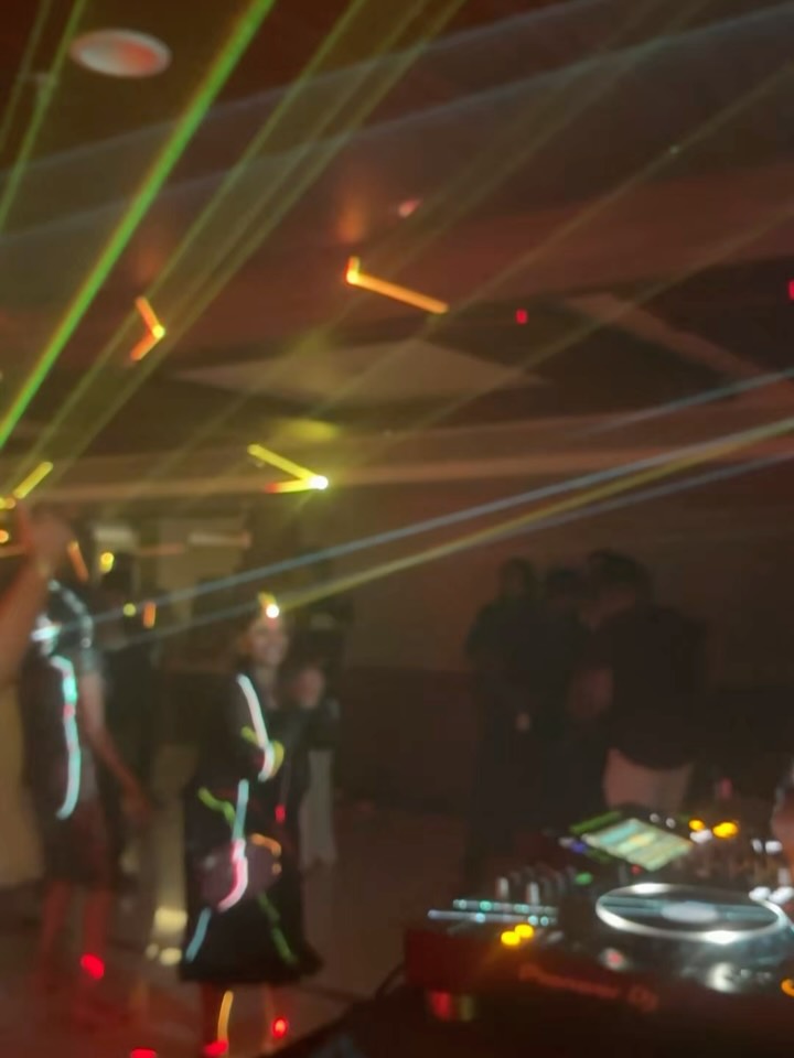 Gossip club dance floor with green and orange laser lights